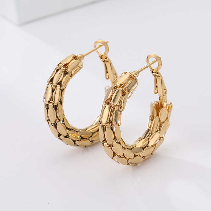 Gold hoop earrings on a white background
