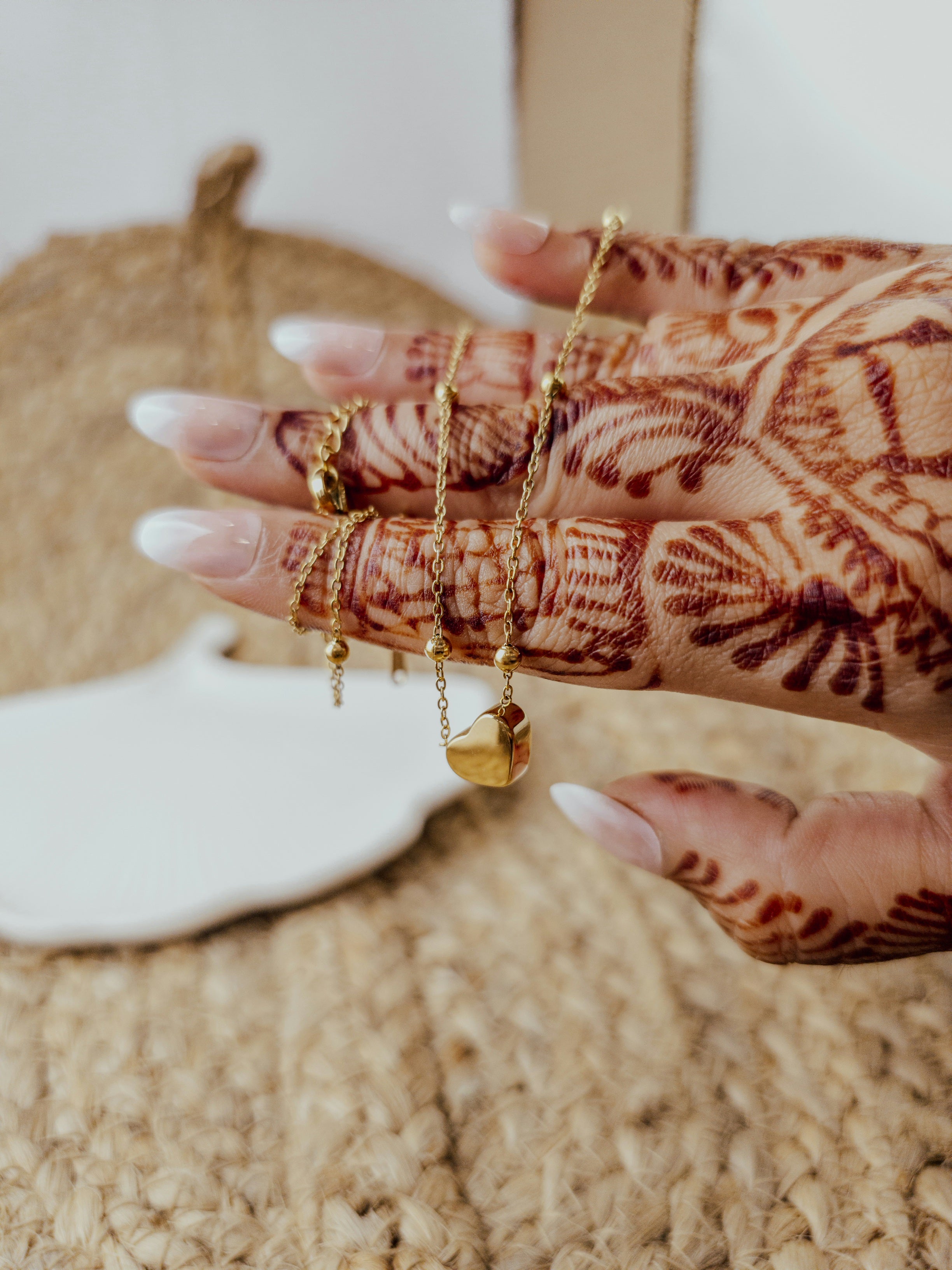 Gold-toned Heart Bead Necklace wrapped on hand with henna design – Zunari Charm