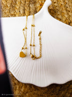Heart Bead Pendant Necklace with clasp on white shell dish – Zunari Charm