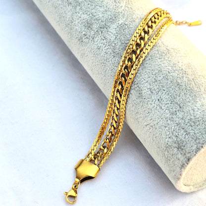 Side view of triple-strand gold bracelet showing the different chain thicknesses.