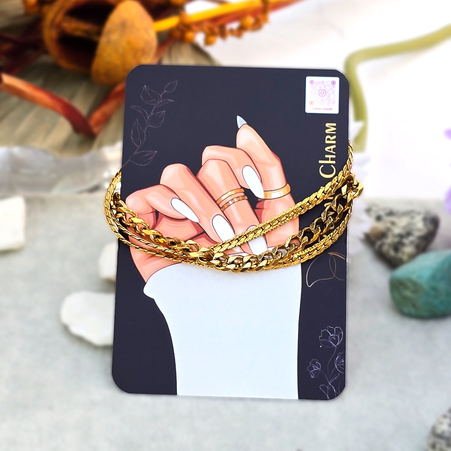 Pre-layered gold stack bracelet displayed on Zunari Charm branding card.