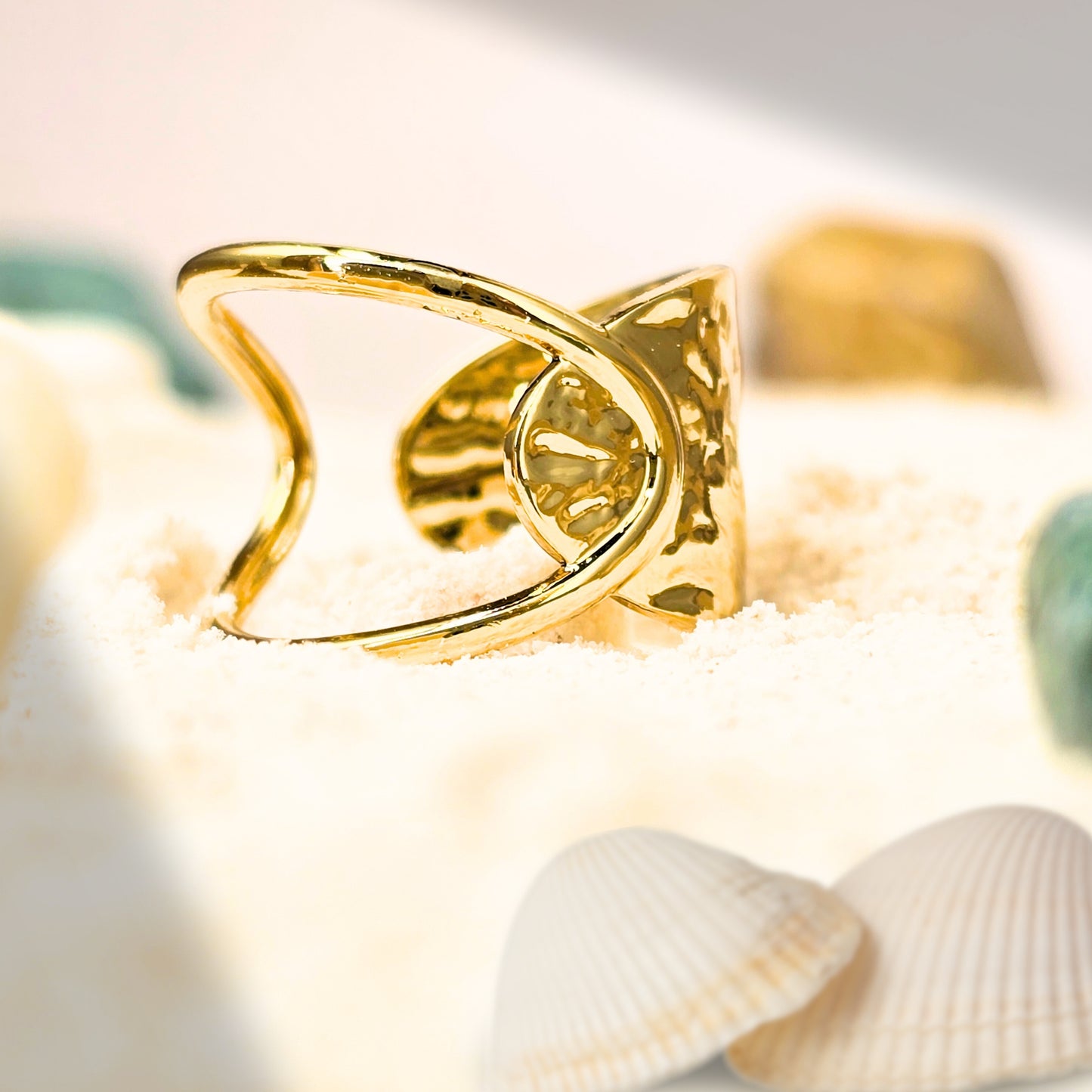 sculptural gold ring on hand aesthetic beach styling