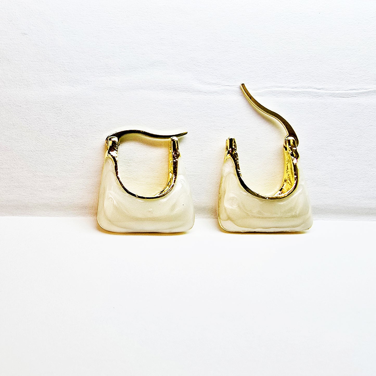 Handbag Earrings – ivory and gold tote-inspired hoops on display