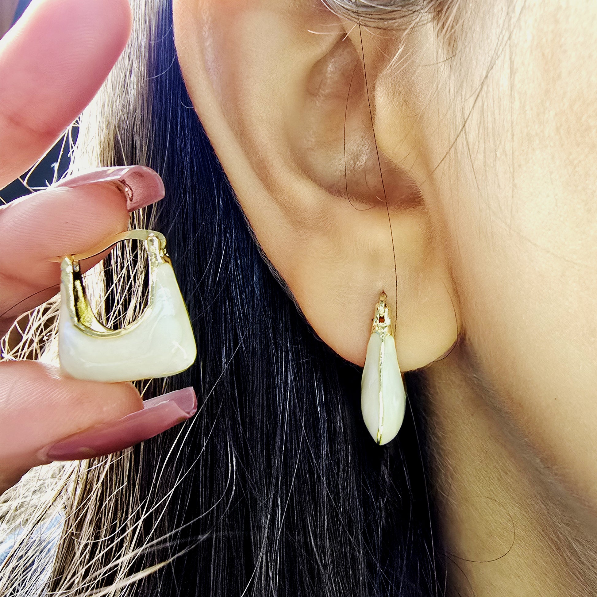 Handbag Earrings – close-up of ivory gold tote-inspired earrings worn on ear
