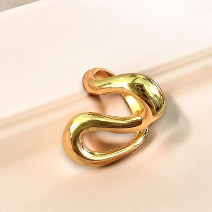 Zunari Charm Infinity Flow Ring with abstract wavy design in gold, displayed on soft beige background.