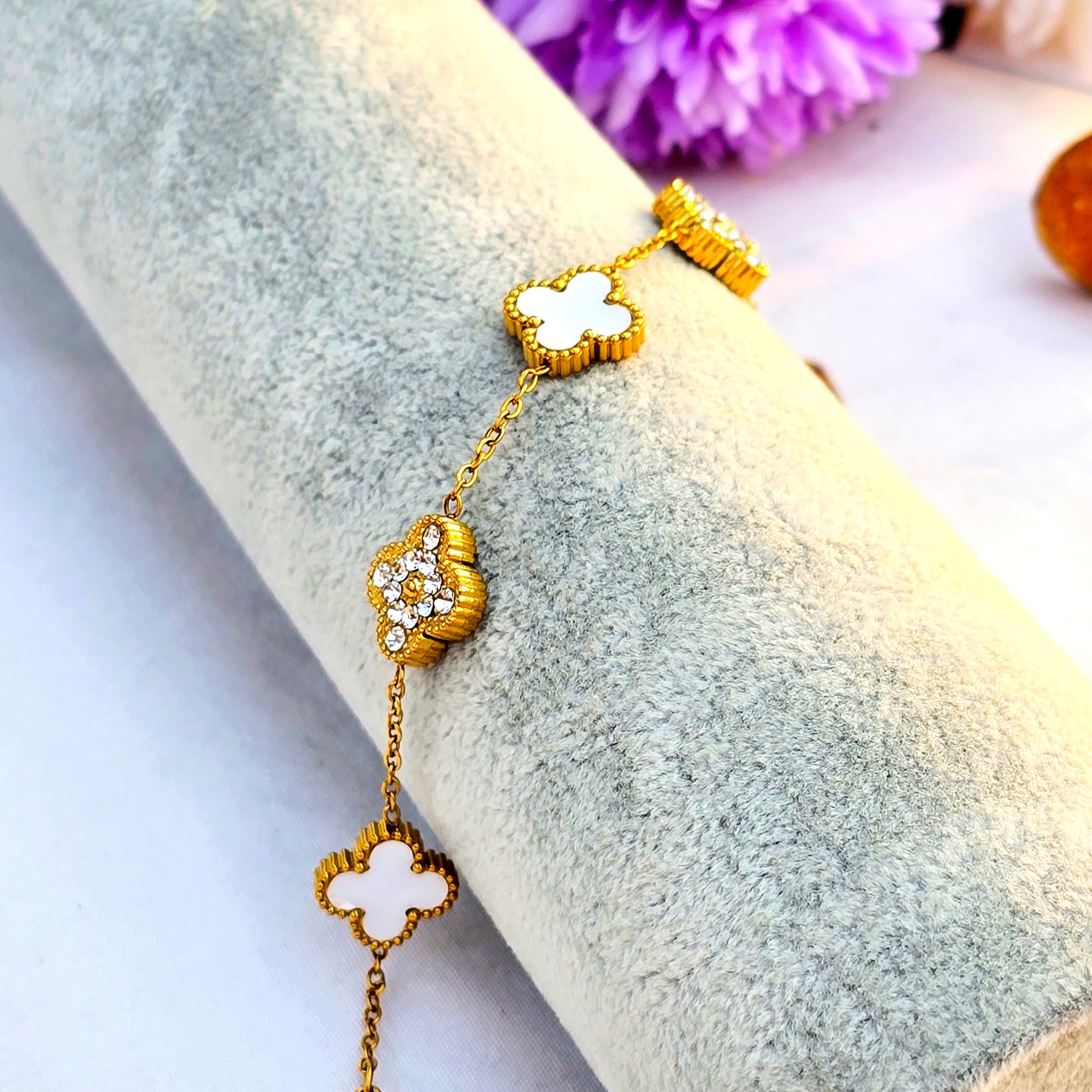 Side view of ivory and pave clover bracelet showing gold plating quality.