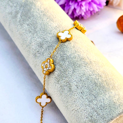 Side view of ivory and pave clover bracelet showing gold plating quality.