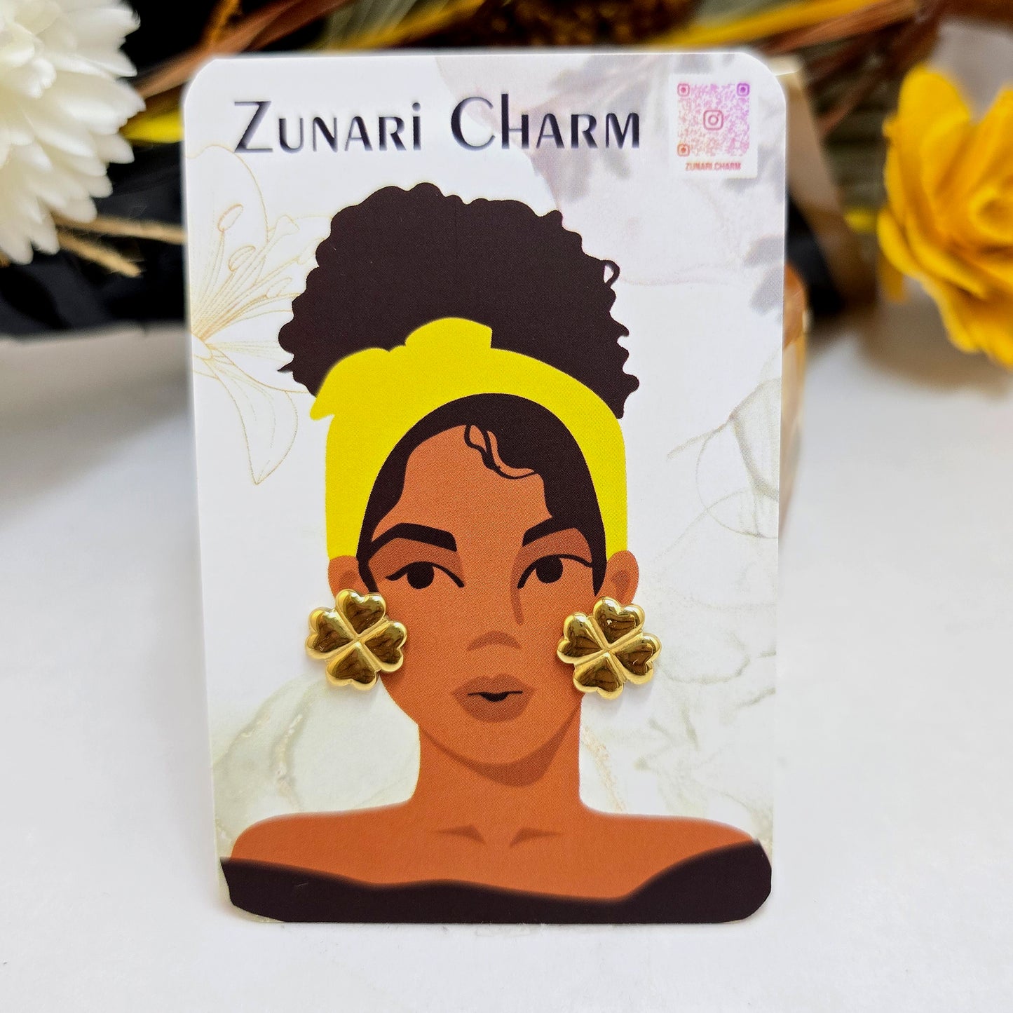 Kismet gold clover earrings presented on a Zunari Charm branded card with the signature yellow-turban illustration.