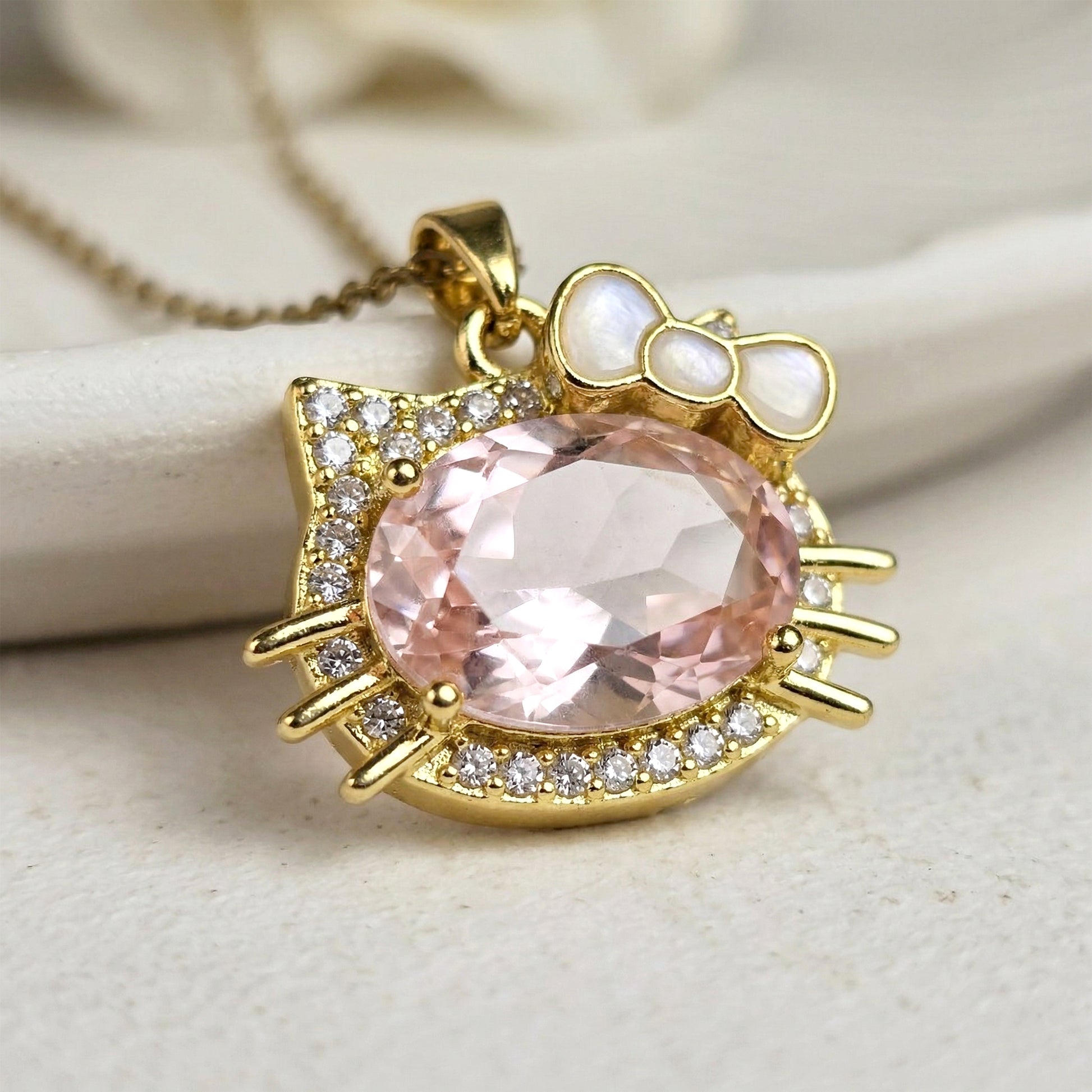 close up kitty pendant pink gemstone crystal detailing
