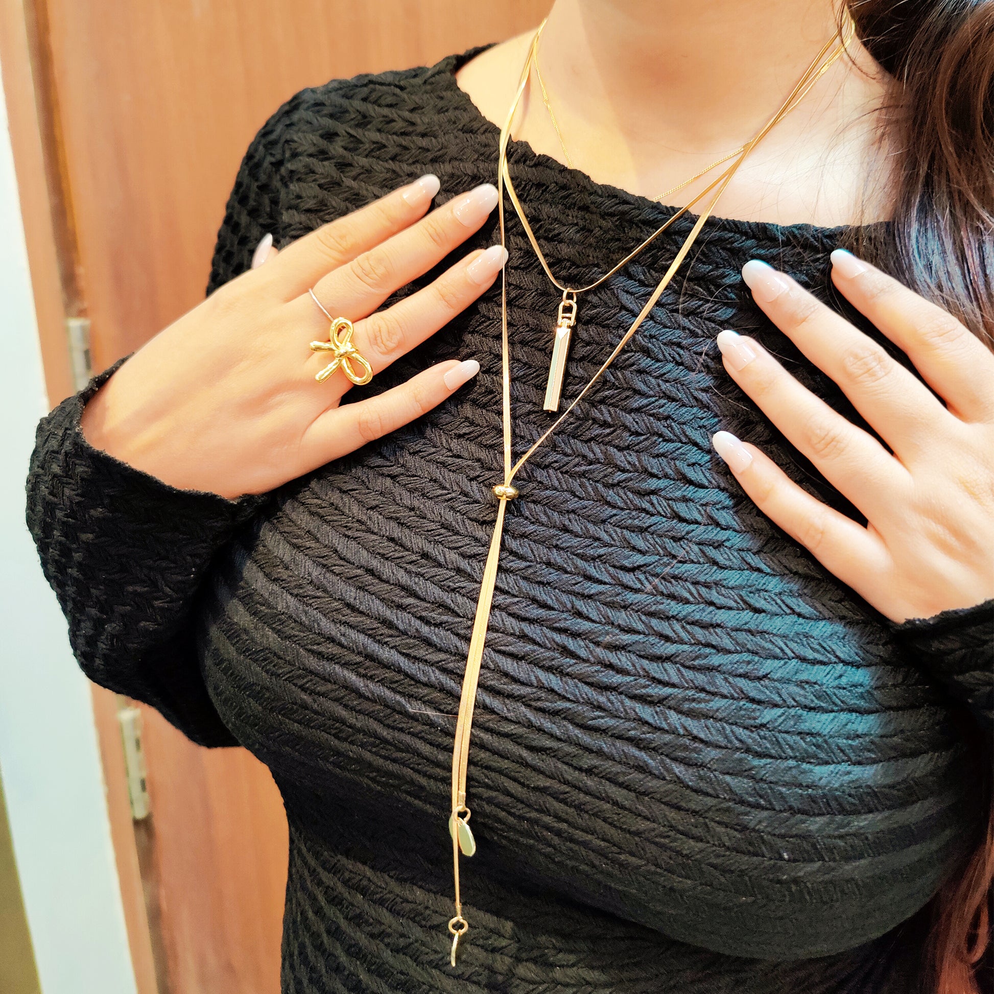 Model wearing Layered Charm Drop Necklace – gold bar and coin pendant