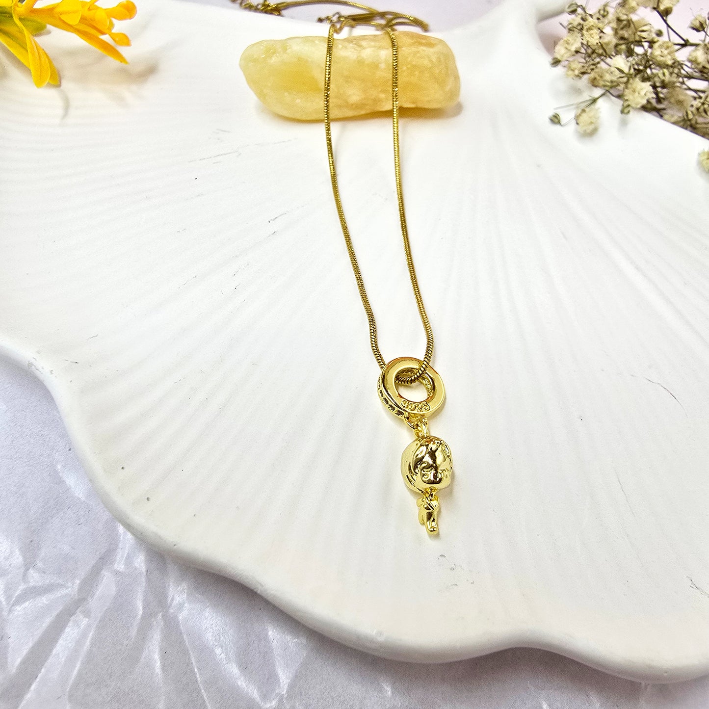 Flatlay of Little Girl 3D Necklace on white shell dish – gold pendant chain