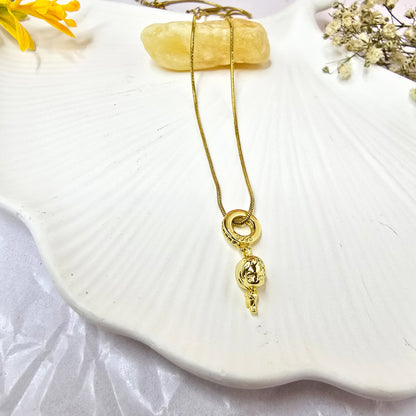 Flatlay of Little Girl 3D Necklace on white shell dish – gold pendant chain