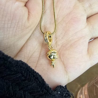 Close-up of Little Girl 3D pendant charm in hand – gold and crystal detail