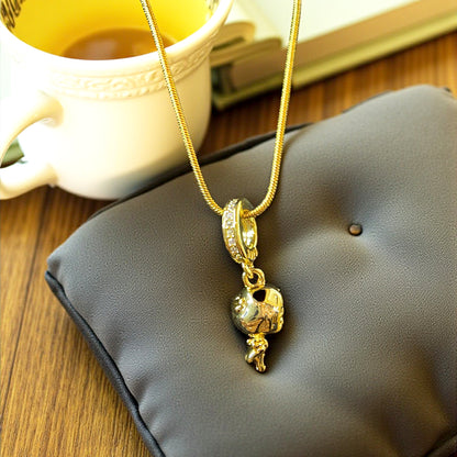 Little Girl 3D Necklace displayed on grey cushion with teacup background – lifestyle shot