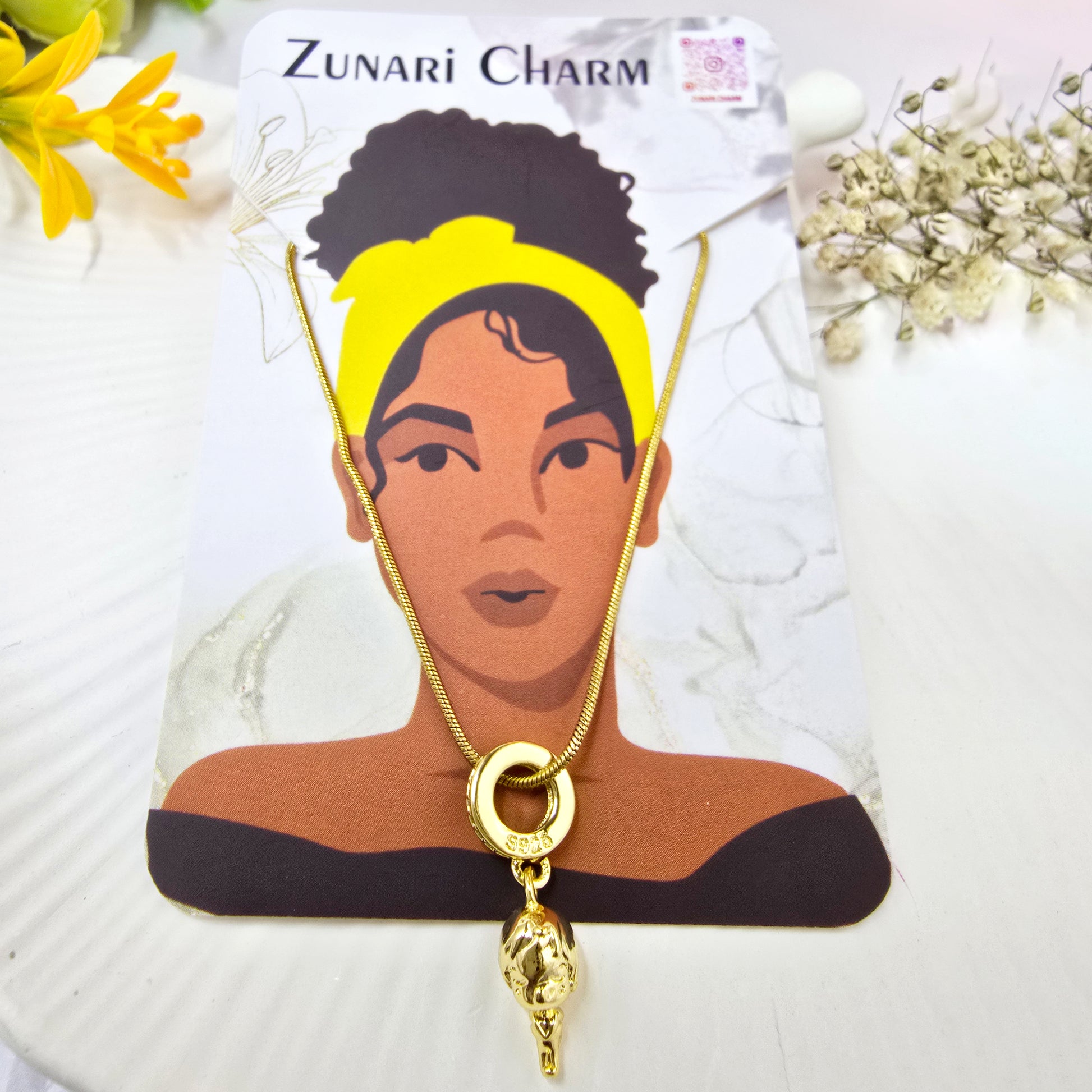 Necklace displayed with Zunari Charm packaging card – gold pendant jewelry