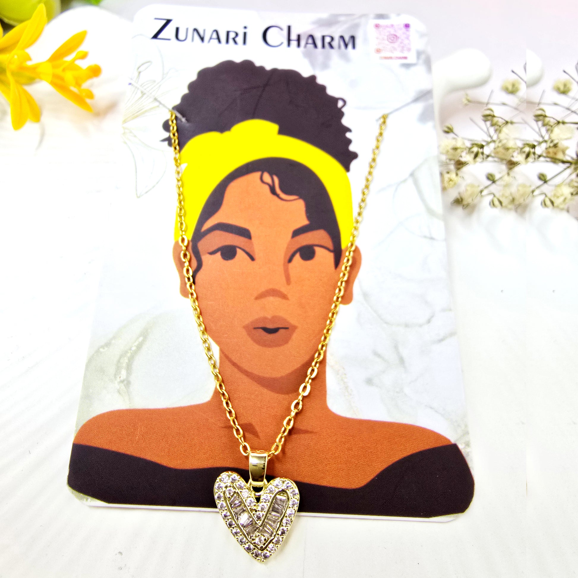 Zunari Charm heart pendant necklace displayed on a branded jewelry card.
