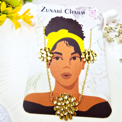 Zunari Charm gold marigold necklace displayed on a branded jewelry card.