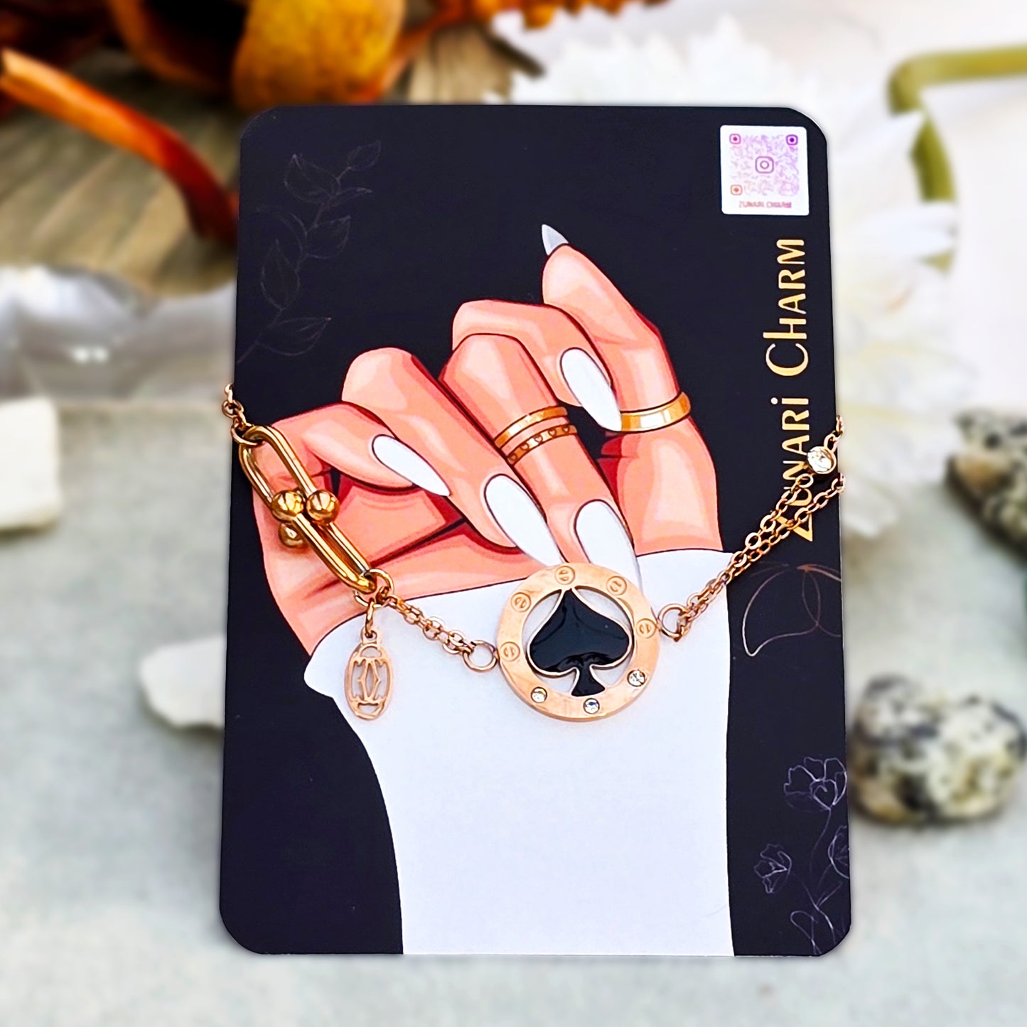 The Midnight Spade Bracelet presented on the official Zunari Charm branding card.