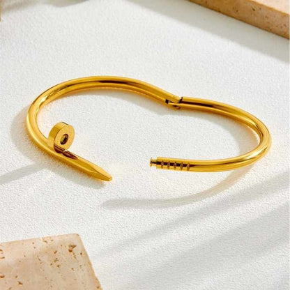 Open view of the gold nail bracelet showing clasp mechanism