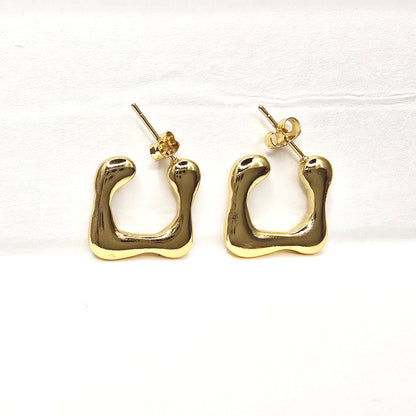 Modern Melt Earrings – Gold abstract hoops on white background