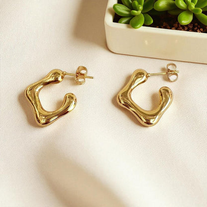 Modern Melt Earrings styled on satin fabric for elegance