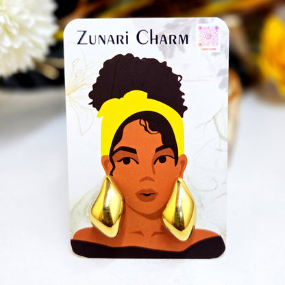Molten gold studs presented on a Zunari Charm branded card featuring an illustrated woman with a yellow turban.