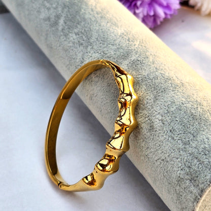 Molten Ridge bracelet showcasing sculptural gold finish