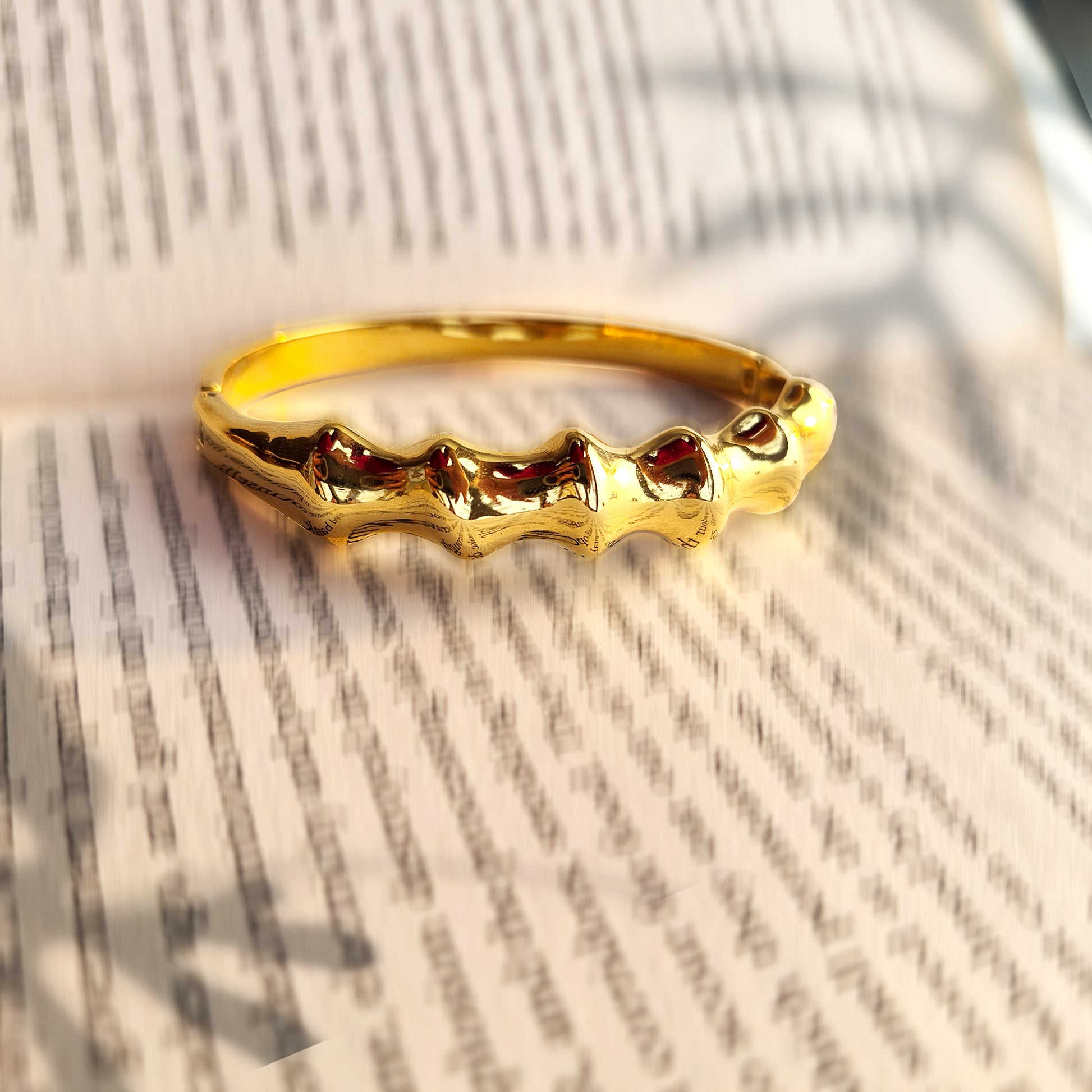 Gold statement bracelet with modern artistic silhouette