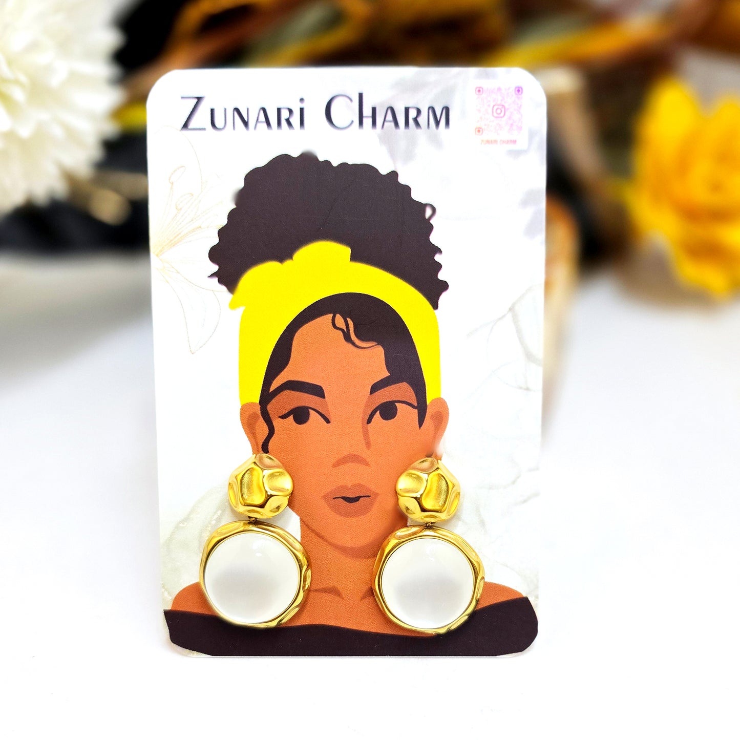 Moon drop earrings displayed on a Zunari Charm branded card featuring an illustration of a woman in a yellow turban.