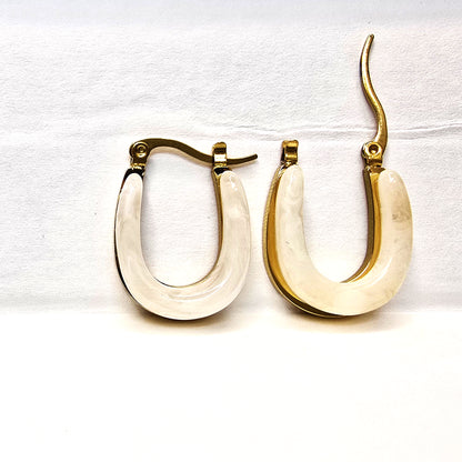 Moonlit Loop Earrings – ivory and gold U-shaped hoops on display