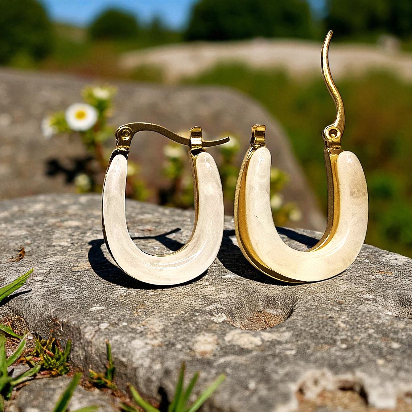 Moonlit Loop Earrings – gold and ivory hoops placed outdoors in sunlight