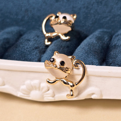 cute cat earrings flatlay aesthetic jewelry styling