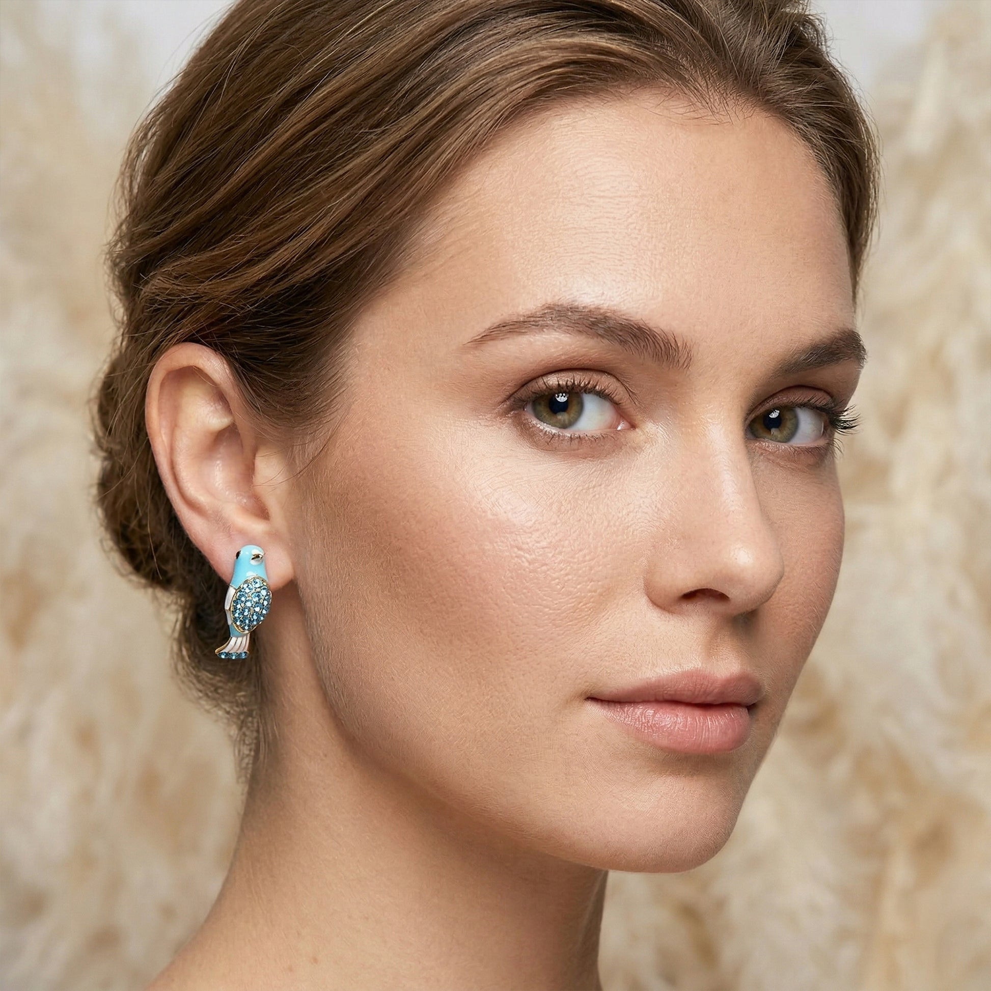 Blue bird earrings worn by model close-up