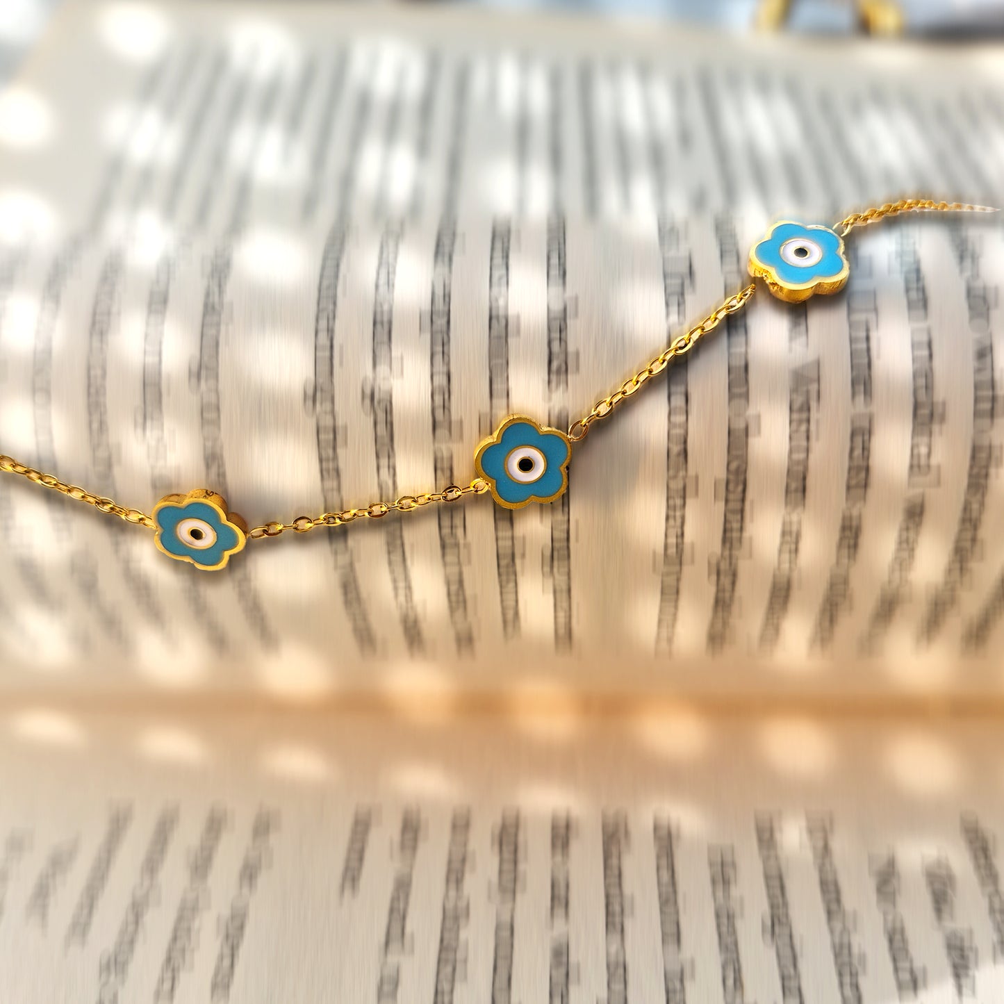 Close-up detail of the deep teal enamel texture and the central crystal star motif on a book.
