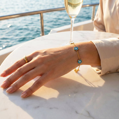 Woman wearing the Mystic Teal Bracelet, showing the contrast of the turquoise enamel against the skin.