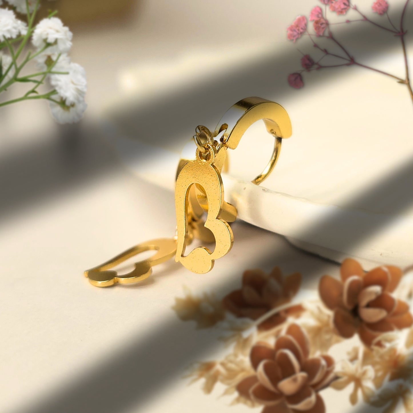 small gold hoop earrings with heart drop charm