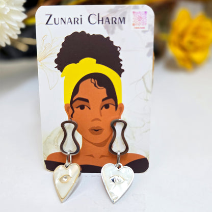 Prism Eye heart earrings displayed on a Zunari Charm branded card with the signature yellow-turban woman illustration.