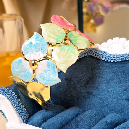 Gold cuff bracelet with pink blue green petal design