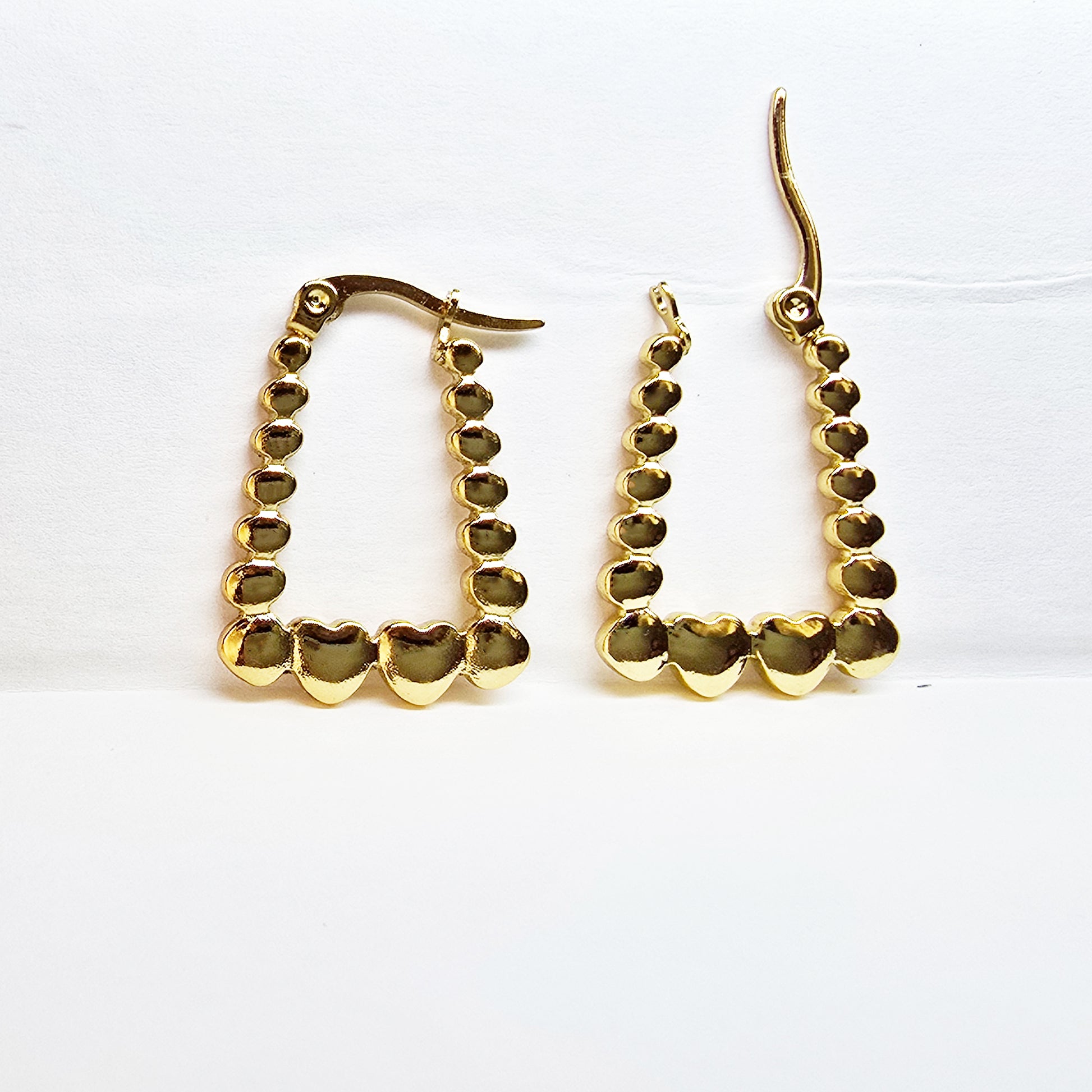 Rectangle Heart Hoop Earrings – gold geometric hoops with bold heart accents on white background