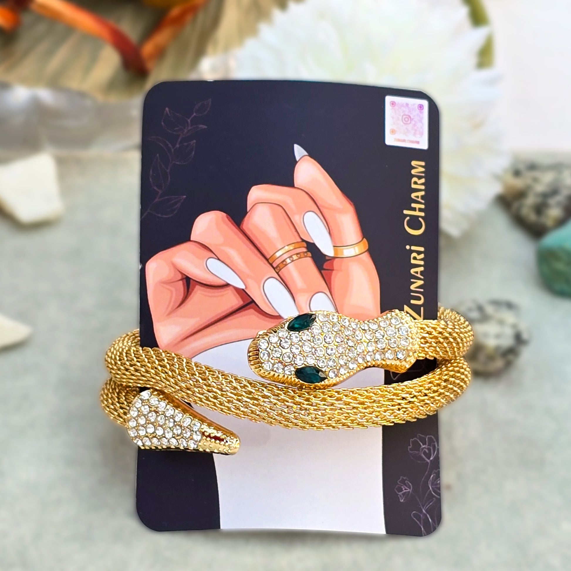 Serpent wrap cuff bracelet displayed on Zunari Charm branded packaging card.