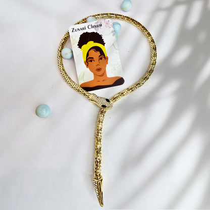 Packaging flatlay – Serpent Embrace Necklace with Zunari Charm brand card