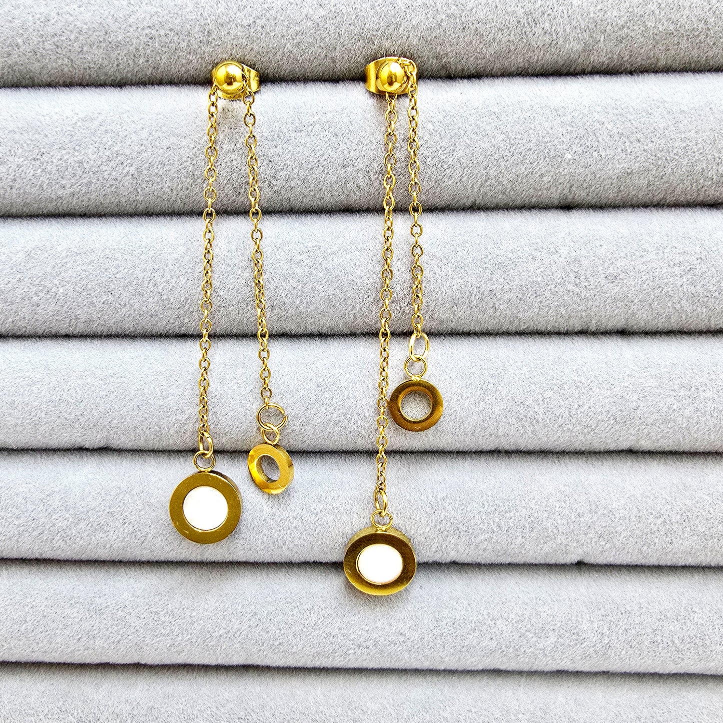 A pair of 18k gold-plated Slide Drop earrings with dual chains and mother-of-pearl inlays in a grey jewelry tray.