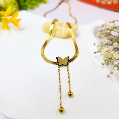 Snake Chain Butterfly Necklace on shell background – gold butterfly pendant with double chain drops.