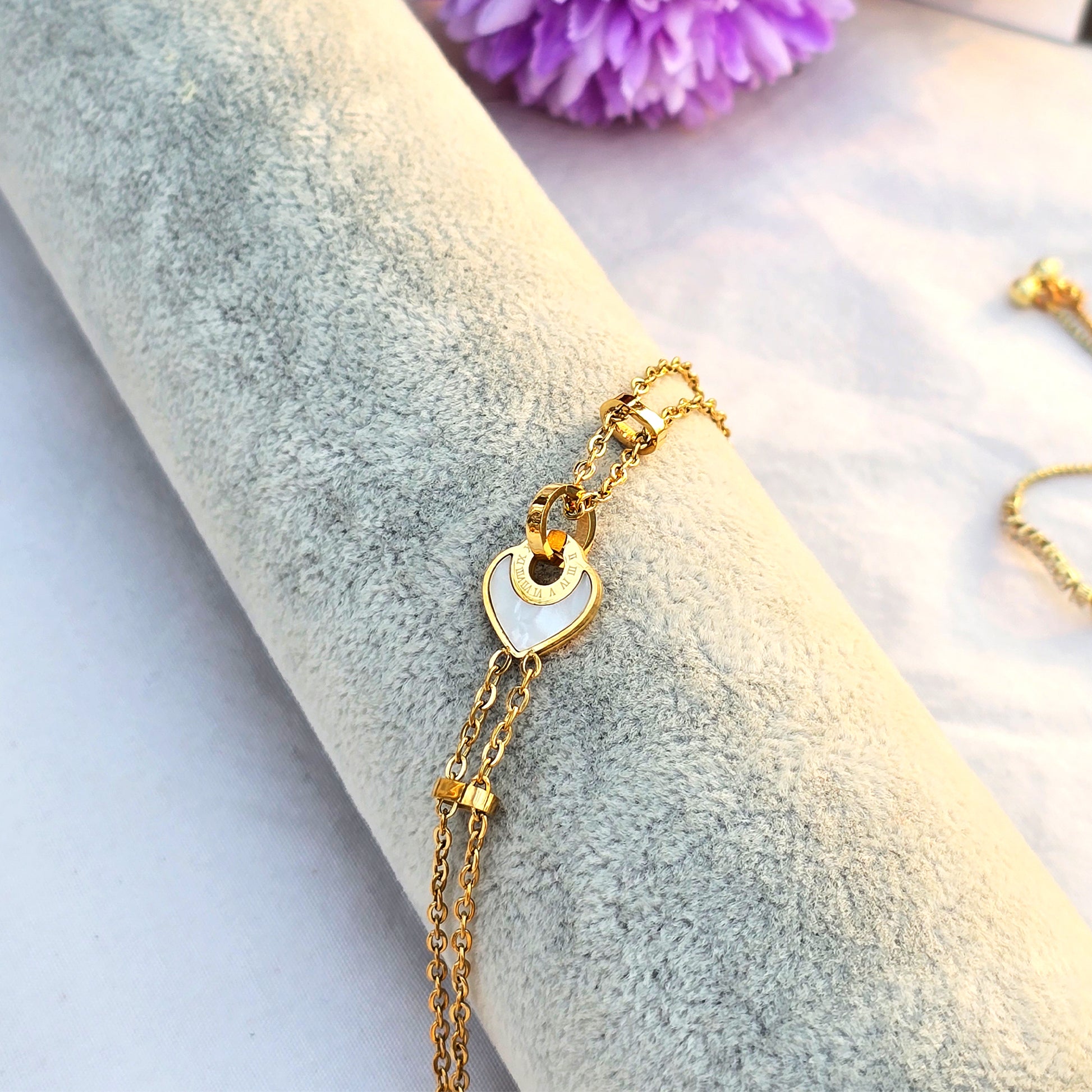 Side view of delicate gold chain bracelet showing clasp and extender.