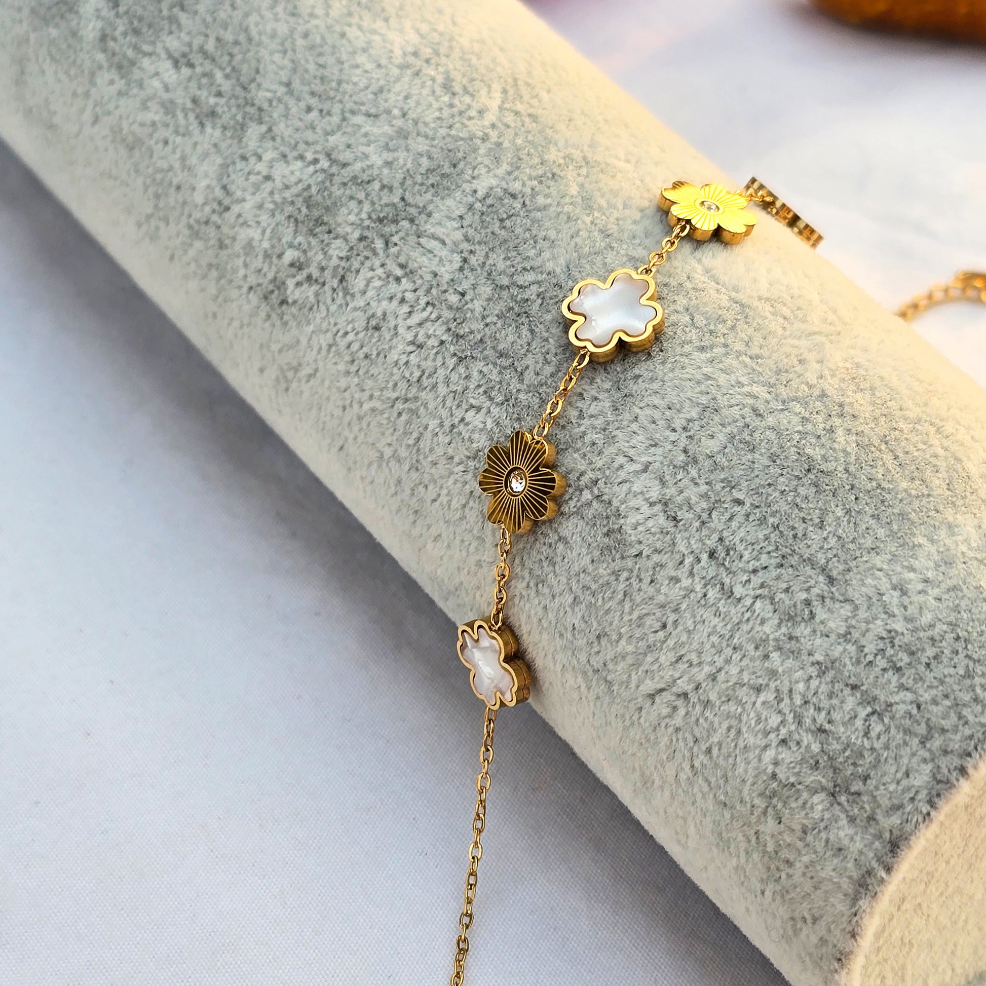 Side view of Sunlit Ivory bracelet showing detail of gold sunburst texture and crystal center.