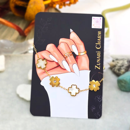 Sunlit Ivory and gold clover bracelet displayed on Zunari Charm branded packaging card.