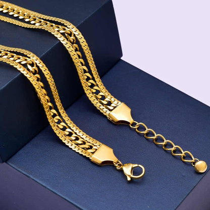 Gold chain necklace on a blue surface
