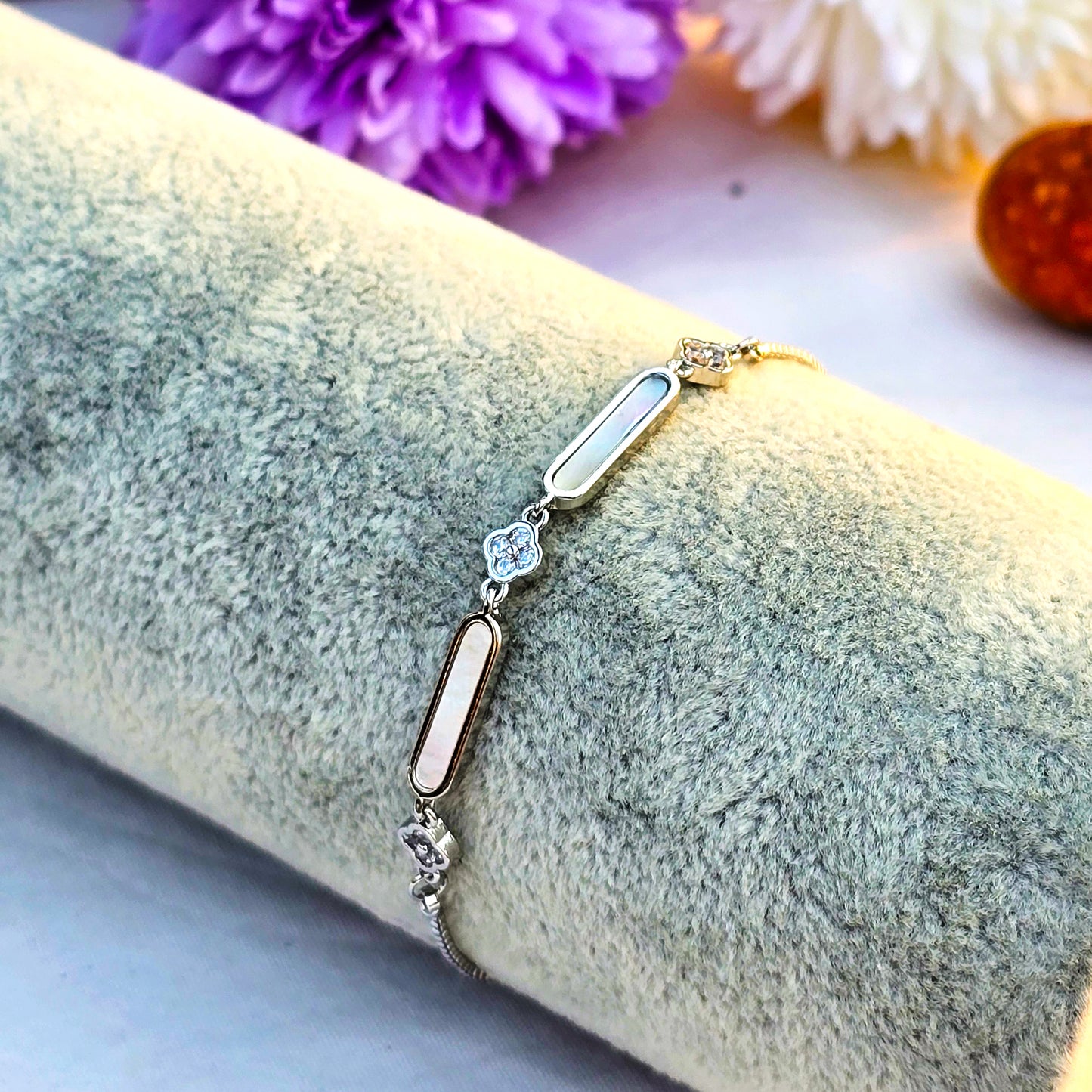 Studio shot of a silver chain bracelet featuring a rectangular bar encrusted with clear pave crystals.