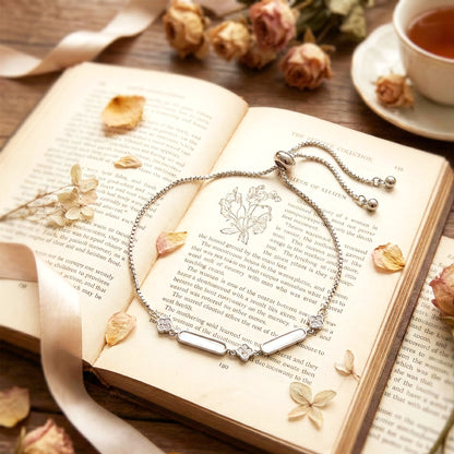 Close-up macro shot of the pave setting on the silver bar, resting on a book.