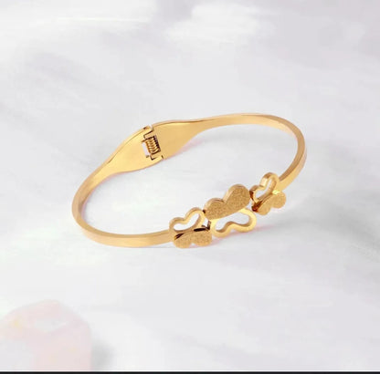 Triple Butterfly gold bracelet on white background – clasp visible
